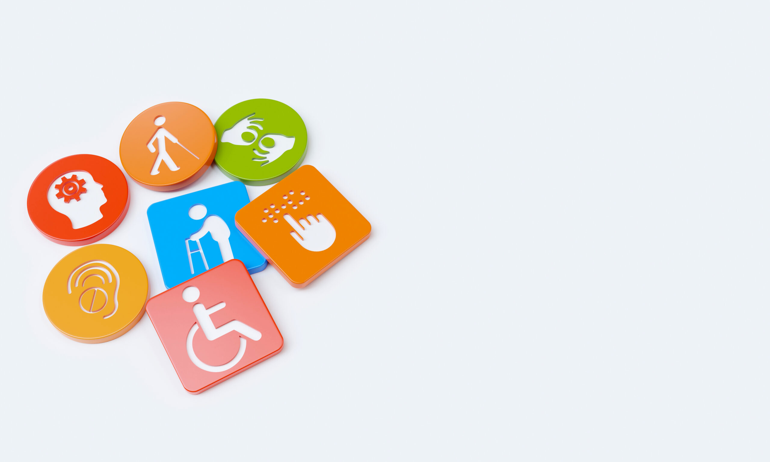 ikony symbolizujące różne niepełnosprawności na okrągłych i kwadratowych płytkach.
